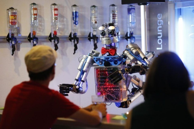 Robotlaşacak 19 iş kolu... Humanoid robot bartender "Carl" interacts with guests at the Robots Bar and Lounge in the eastern German town of Ilmenau, July 26, 2013. "Carl", developed and built by mechatronics engineer Ben Schaefer who runs a company for humanoid robots, prepares spirits for the mixing of cocktails and is able to interact with customers in small conversations. Picture taken July 26, 2013. REUTERS/Fabrizio Bensch (GERMANY - Tags: SOCIETY SCIENCE TECHNOLOGY BUSINESS TPX IMAGES OF THE DAY)