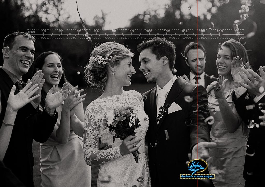 Full length portrait of newlywed couple and their friends at the wedding party showered with confetti in green sunny park; Shutterstock ID 247462639