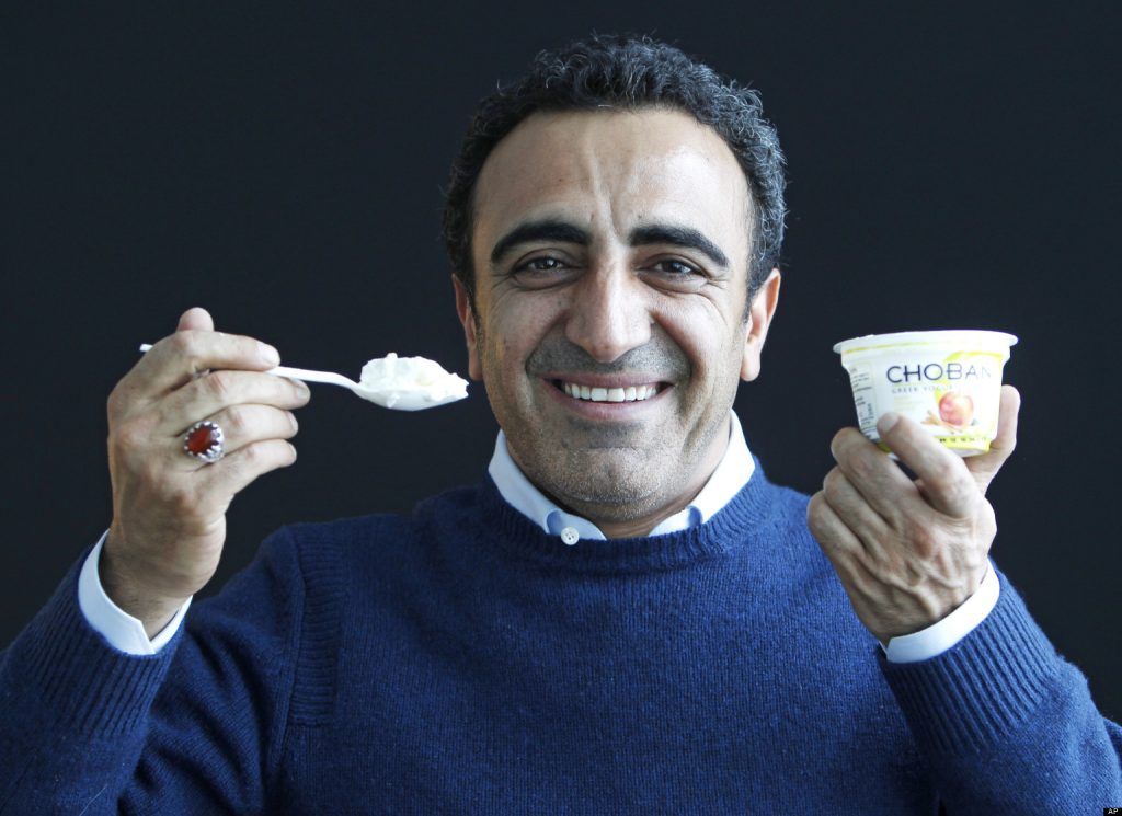 In this Jan. 13, 2012 photo, Hamdi Ulukaya, CEO of Chobani Greek Yogurt, poses at the Chobani plant in South Edmeston, N.Y. Greek yogurt now accounts for a quarter of the total yogurt market after a dizzying growth spurt that is especially apparent here in the heart of upstate New York. The nation's No. 1 and No. 2 Greek yogurt brands  Chobani and Fage, respectively  are both expanding plants within 60 miles of each other, and another company is building a plant in western New York. The expansions come as the big U.S. yogurt makers are focusing on Greek products, too. (AP Photo/Mike Groll)